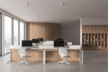 Wooden office workspace interior with pc desktop on table, panoramic window