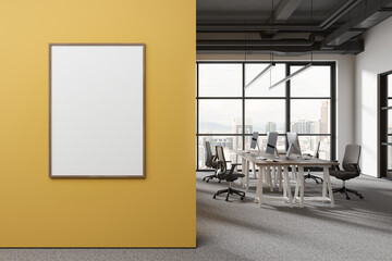White and yellow open space office with poster