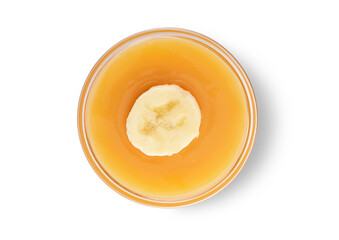 Fresh mashed bananas with slice in bowl on white background.Top view.Macro.