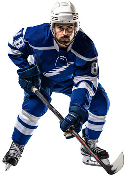 A hockey player in a blue and white uniform stands on the ice with a stick in his hands. Isolated on a transparent background