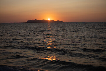 Sunset by the sea with a view of Favignan Island