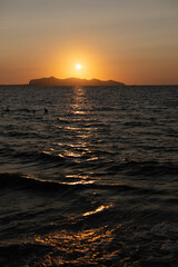 Sunset by the sea with a view of Favignan Island