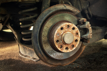 Rusty brake discs on an abandoned car. Object illuminated with soft, natural light