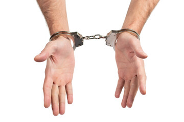 Man's hands in handcuffs on a white background, isolated