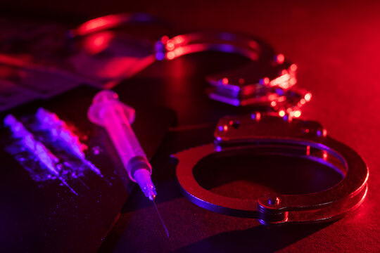 Handcuffs, drug syringe and drug powder and money