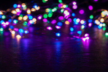 Abstract Christmas lights on black background. Glowing light bulb garland,