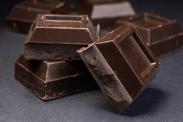 Dark chocolate stack, chips and powder close up