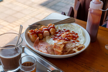 Breakfast sets, hot drinks and condiments are set on the table.