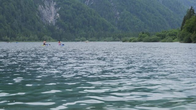 Lake Lago del Predil in Italy in Summer with People on Paddle Boards