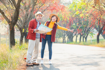 Fototapeta premium senior man father and young woman daughter standing by the street,find a location on a map for travel in the city
