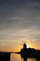 Sunset over a salt mill in Marsala, Sicily
