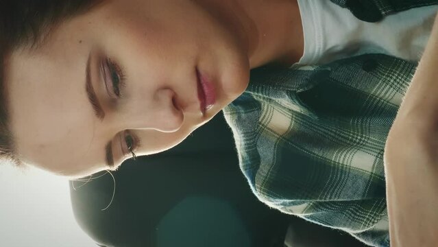 Close up of professional woman tailor sews on overlock machine. Vertical video