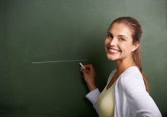 Woman, teacher portrait and drawing on chalkboard for education, learning information and teaching. Face of a young professor, lecturer or class educator writing a line on board for school knowledge