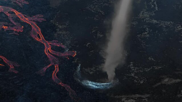 Dramatic shot of area near an active volcano, eruption producing red hot lava and pyroclastic flows, lahars, landslides and debris flows, aerial view.