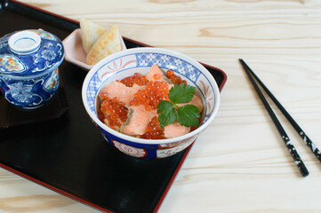 Harako-meshi is one of traditional dishes in Watari area in Miyagi , Japan, which consists of salmon and salmon roe (harako) on cooked rice.. It' is also one of the most popular autumn delicacies.