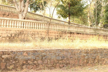 Long Indian style or Rajasthani railing in the middle of Chandrashekhar farm, bhondsi, in bright...