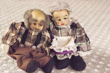 elderly couple and retirement concept. Mature couple in love. Porcelain dolls are hugging, grey haired husband and wife. Old age presentation