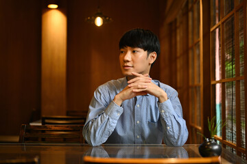 Portrait image of a Confident and Smart Young Asian Businessman in the Japanese restaurant