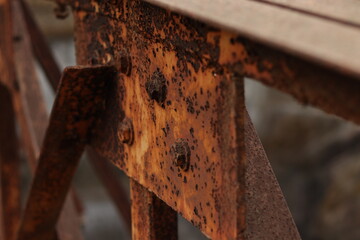 A Closeup shot of a rusted iron bridge in selective focus