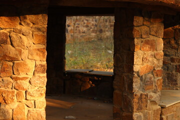 Shot of a vertical column beam or pillar made up of stone brick and blocks of red color under the sunlight, multiple column