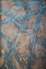 The background of the metal sheet is rusty blue with diagonal stripes.  Construction interior...