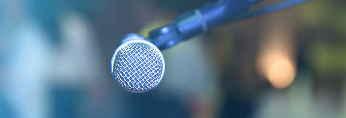 Microphone on abstract blurred hall lights.