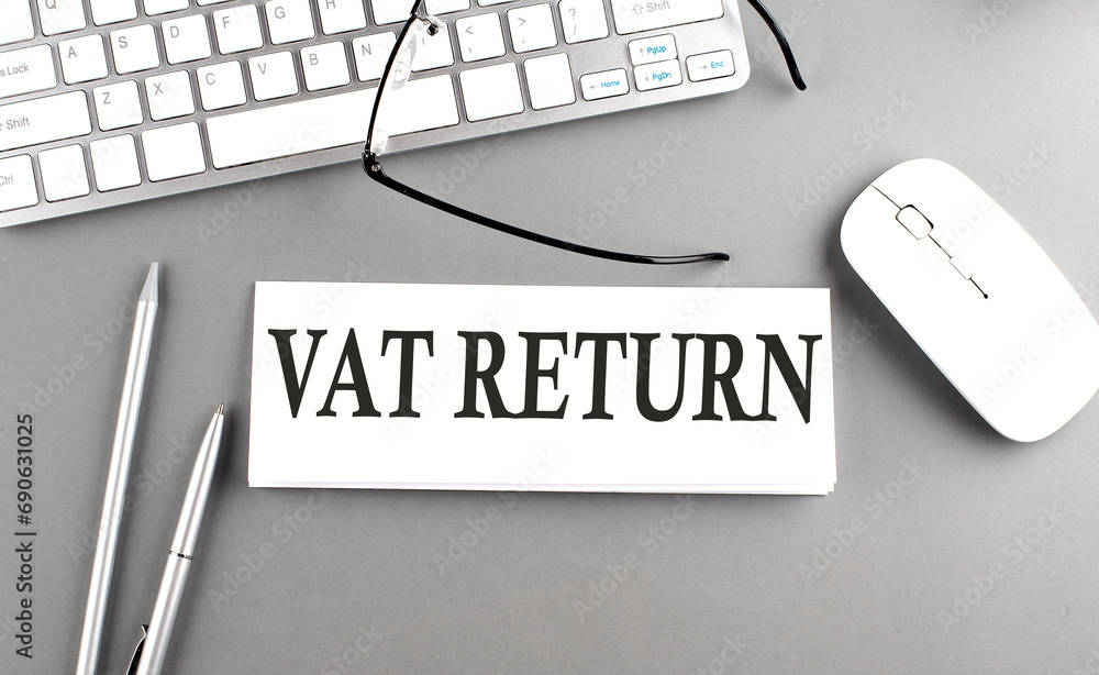 Poster vat return text on paper with keyboard on grey background