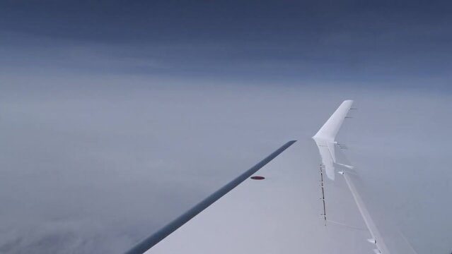 Airplane Wing view Outside clouds sky business jet aircraft