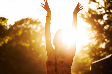 Woman, sunset and outdoor festival for party, event or holiday weekend with arms up in nature...