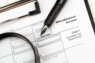 IRS Form 1099-misc Miscellaneous income blank on A4 tablet lies on office table with pen and...