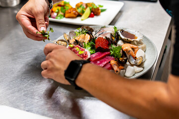 chef hand cooking Set Mixed Seafood in plate