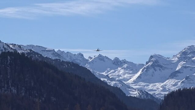 Private Jet Silhouette Generic Final Approach for landing at Mountain valley regional winter frozen cold skiing airport sankt moritz switzerland snow
