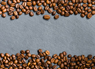 coffee beans on a grey stone board background, top view, copy space