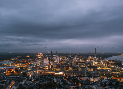 Leverkusen, North Rhine-Westphalia, Germany - November 2023: Aerial night skyline view of the illuminated Chempark (Bayerwerk) plant, industrial park for chemical industry, headquarters of Bayer AG