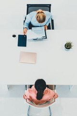 Two young business women in meeting at office table for job application and business agreement....