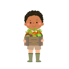 Farmer boy holding wooden box full of fresh raw vegetables