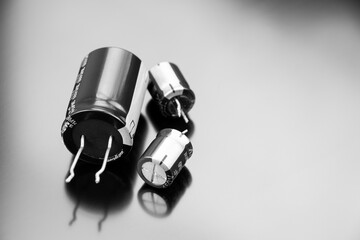 Electrolytic capacitors isolated on a black background. Copy space. Electronic components.