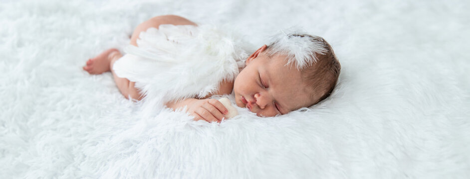 Newborn angel photo session in a suit. Selective focus