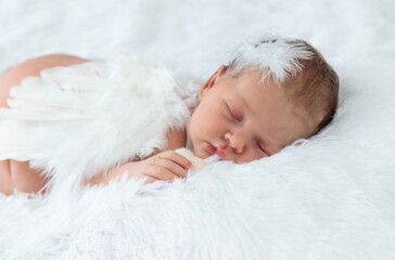 Newborn angel photo session in a suit. Selective focus