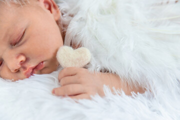 Newborn angel photo session in a suit. Selective focus