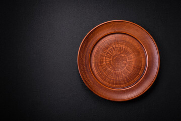 Bumpy empty ceramic plate on a textured concrete background