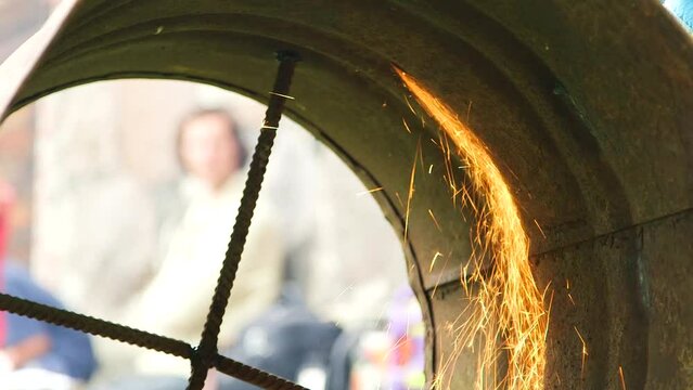 Hand Held Close Up Shot of Sparks Inside Rusty Barrel from Metal Cutter