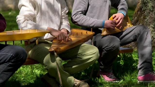 Dolly Medium Shot of Three Men Playing Vintage Traditional Zithers