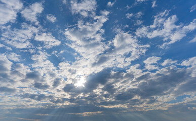 Sun rays break through clouds.