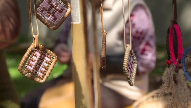 Dolly Close Up Shot of Decorative Pendants and Dream Catchers Swinging in the Wind