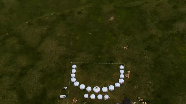 Aerial view of nomadic yurt camp on a meadow