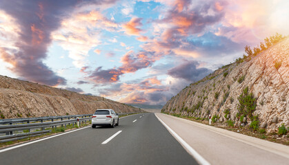 Car on a freeway in a beautiful area.