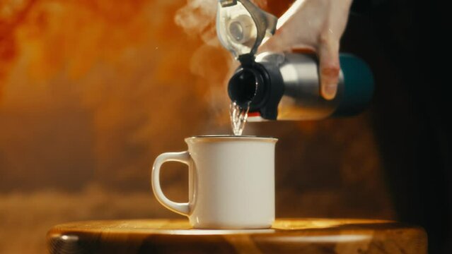close-up of hot tea being poured into a tiny cup. Cinematic video. Ideal for those who love tea drinking.