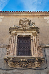 Fototapeta premium old stone window with beautiful old grille in the historic center of the city of Salamanca