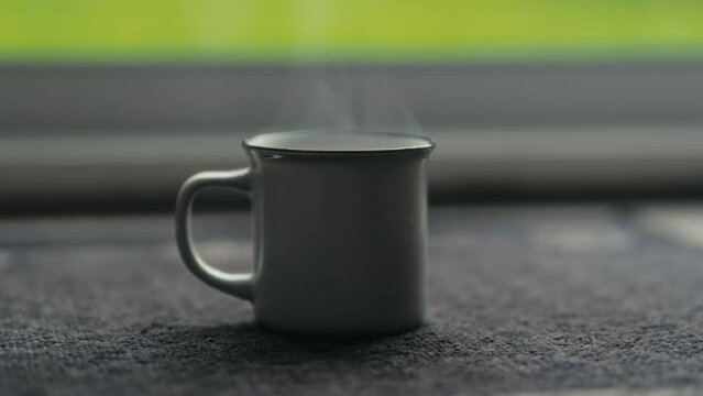 Hot coffee mug in the morning. Delicious drink to start the day. Steaming hot beverage.